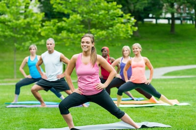 People doing yoga outdoors (iStockphoto.com)