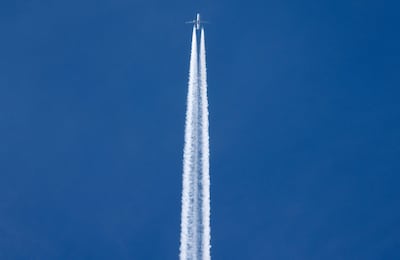 The contrails of an aircraft cruising at altitude over Paris. AFP