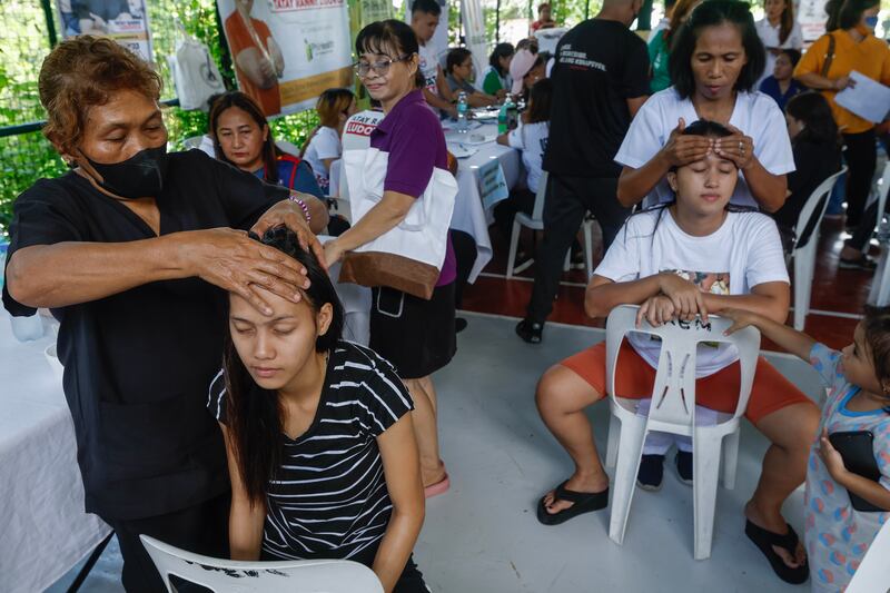 Women receive free massages during a social services event in Quezon City, Metro Manila. EPA