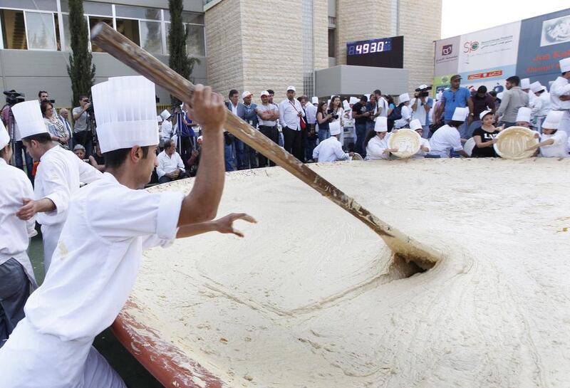 Lebanese chefs prepare hummus, during a bid to break a record previously held by Israel and reclaim ownership over the popular Middle Eastern dish, in Fanar, east of Beirut, Lebanon. A Guinness World Records adjudicator confirmed that Lebanon now holds the record. Hussein Malla / AP Photo