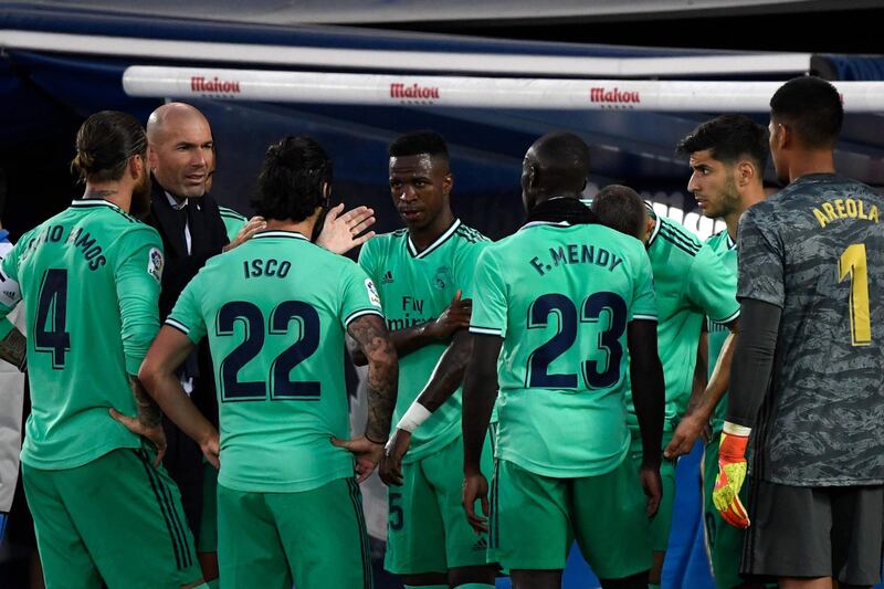 Real Madrid's French coach Zinedine Zidane talks to his players during La Liga  match against Leganes. AFP