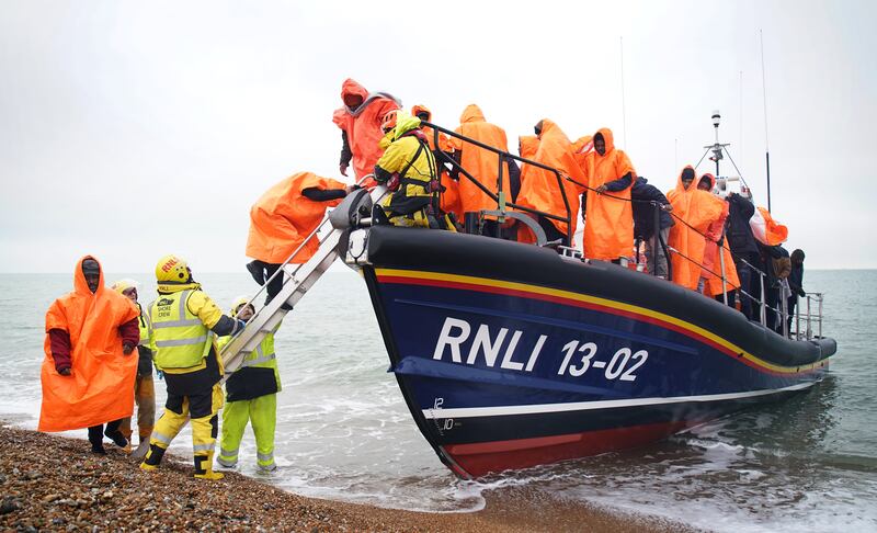 A group of people thought to be migrants are brought to Dungeness, Kent, after being rescued following a small boat incident in the Channel. PA