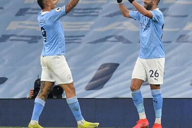 Riyad Mahrez celebrates scoring Manchester City's third against Wolves with Gabriel Jesus. AFP
