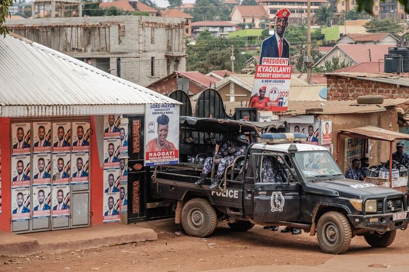 A patrol car of the Ugandan police is seen stationed outside the headquarters of the Uganda oppposition party National Unity Platform (NUP) on January 20, 2021. Uganda's government spokesman on Tuesday accused the US ambassador of breaching diplomatic norms and engaging in "mischief" over her attempt to visit opposition leader Bobi Wine, who is confined to his home.
The former popstar-turned-politician has been under effective house arrest guarded by soldiers and police, since he cast his ballot in last Thursday's presidential election, which he said was riddled with fraud. / AFP / SUMY SADURNI
