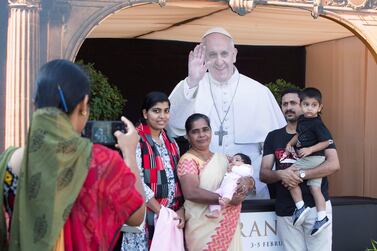 Families gather at the Pope display stall at St. Mary's Catholic Church, Oud Mehta. Leslie Pableo / The National