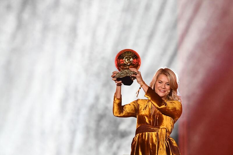Ada Hegerberg brandishes her trophy.  AFP
