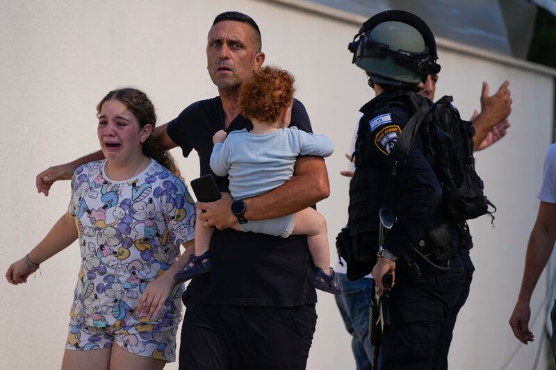 Israeli police evacuate a family from a site hit by a rocket fired from the Gaza Strip. AP