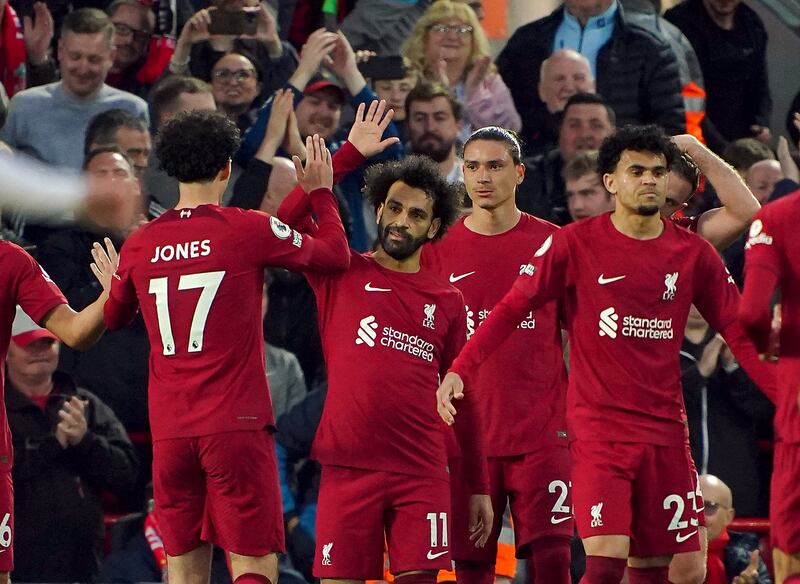 Liverpool's Mohamed Salah celebrates scoring  the first goal with teammates. PA 