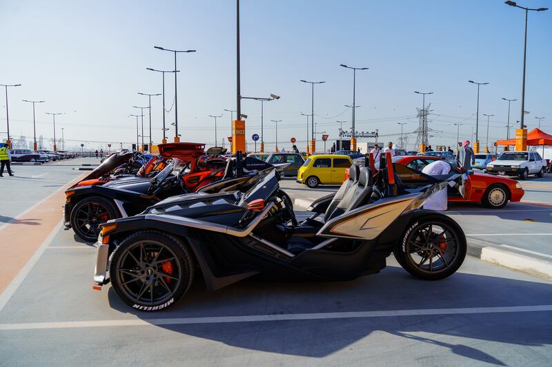 Three-wheelers in a line on the forecourt.