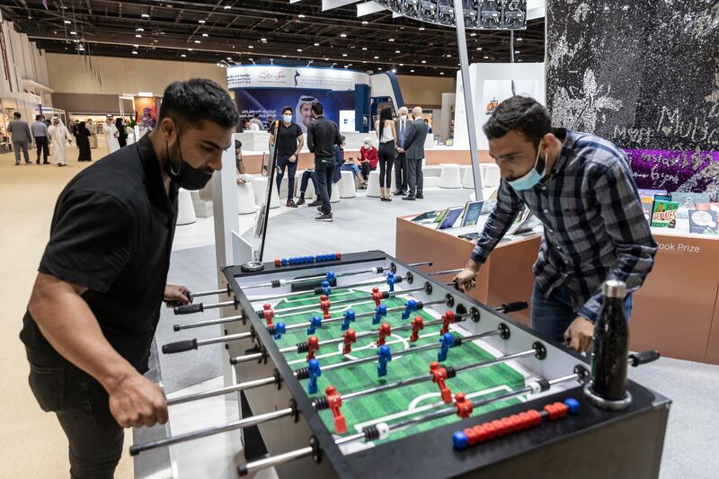 Visitors play foosball at the Germany pavilion on the first day of the event.
