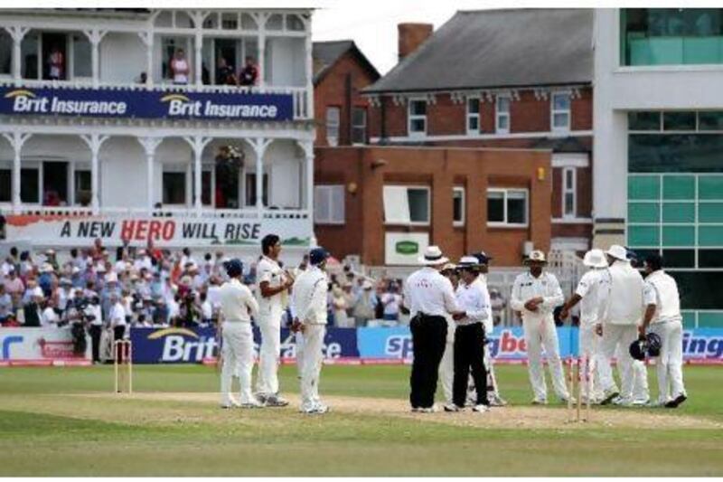 The umpires double-checked with the India captain MS Dhoni, behind umpire Asad Rauf, centre, and Marais Erasmus, to ensure if he still wanted to call for the run out. But when an attempt to reverse it emerged, both umpires stepped away from the spotlight and let common sense prevail.