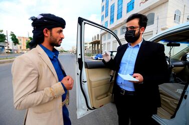 Yemeni physician Sami al-Hajj provides free medical service from his car in the capital Sanaa on June 2, 2020 during the COVID-19 coronavirus pandemic crisis. In a war-ravaged country now battling coronavirus, the Yemeni doctor has hit the road to dispense medical advice from his car, gathering a large social media following along the way. "Stop me if you need a medical consultation," reads a large sticker on the rear window of Sami Yahya al-Hajj's four-wheel drive, alongside a cartoon figure of the bearded doctor wearing his square spectacles. / AFP / Mohammed HUWAIS