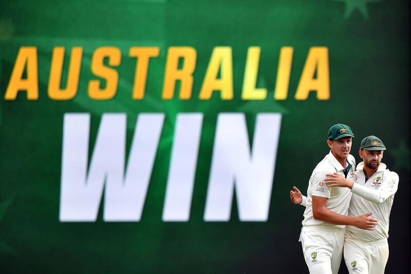 Australia's paceman Josh Hazlewood (L) and spin bowler Nathan Lyon (R) celebrate their victory in the first Test against Pakistan at the Gabba in Brisbane. AFP