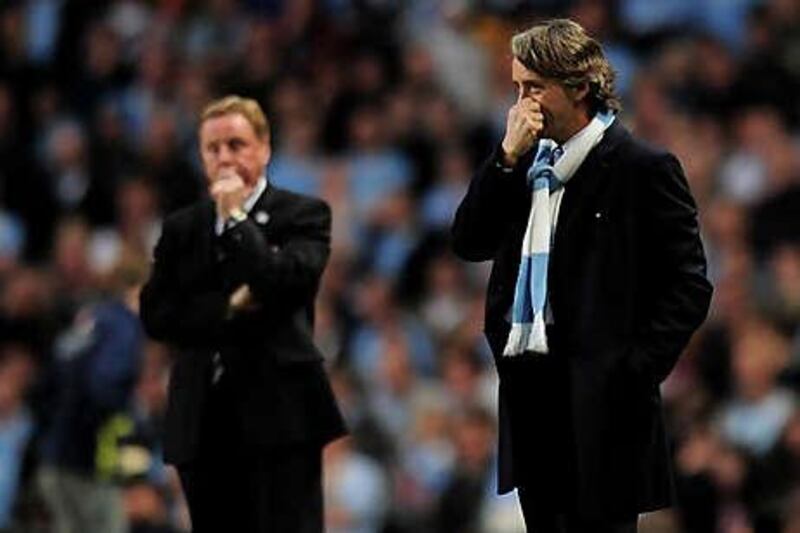 Manchester City's Roberto Mancini, right, and Tottenham's Harry Redknapp watch their teams in the final game of last season.