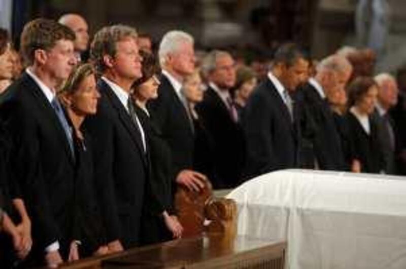 The casket of Senator Edward Kennedy sits between his family, from the left;  his son Congressman Patrick Kennedy, daughter Kara Kennedy Allen, son Edward Kennedy Jr., widow Vicki Reggie Kennedy,  former President Bill Clinton, Secretary of State Hillary Clinton, former President George W. Bush and his wife Laura, President Barack Obama and first lady Michelle Obama, Vice President Joseph Biden and his wife Jill, former first lady Rosalynn Carter and former President Jimmy Carter, during funeral services at the Basilica of Our Lady of  Perpetual Help in Boston, Massachusetts Saturday, August 29, 2009. Senator Kennedy died late Tuesday after a battle with cancer. He was 77. (AP Photo/Brian Snyder, Pool)  *** Local Caption ***  BOS921_Kennedy_Funeral.jpg