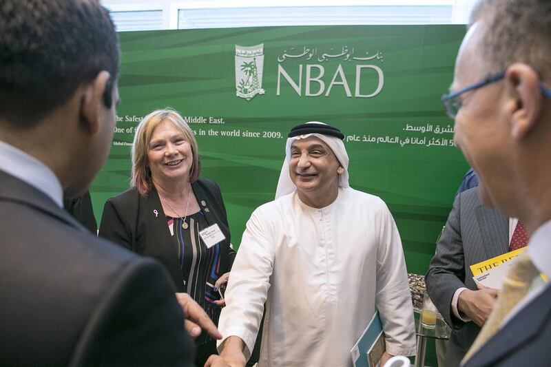 Noeleen Saeed of Abu Dhabi Holding, left, and Waheeb Ahmed Al Attar, head of multinational business corporate banking at National Bank of Abu Dhabi, centre, with other guests at the 6th Annual Global UAE Investment Forum. Silvia Razgova / The National