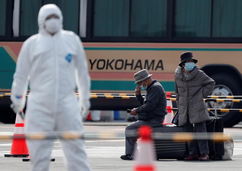 Passengers wait for transportation after leaving the coronavirus-hit Diamond Princess cruise ship docked at Yokohama Port, south of Tokyo, Japan, February 20, 2020. REUTERS/Kim Kyung-Hoon