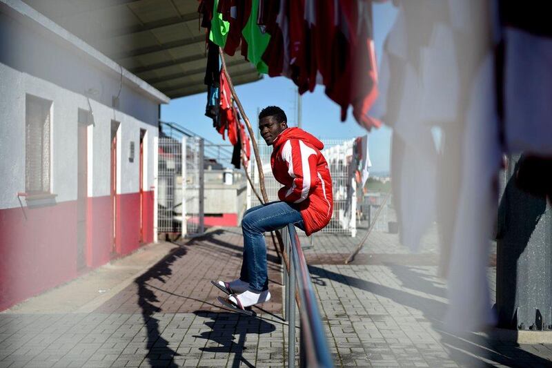(Click on arrow to the right to scroll through photos) Nigerian Sunday Akoh, 20, sits on a rail waiting for the lunch at the AD Nogueirense sporting association at Nogueira do Cravo on February 19, 2016. AFP / PATRICIA DE MELO MOREIRA
