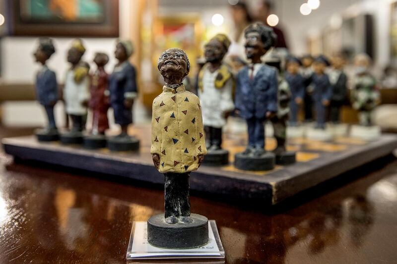 A chessboard, showing black members of South Africa’s post-apartheid government, left, including late President Nelson Mandela, centre, as the king figurine, and white members of the cabinet of apartheid-era President Pieter Willem Botha, is displayed on July 15, 2014 during an exhibition viewing before the Mandela Auction on July 17 at the Stephan Welz & Co auction house in Johannesburg. Two-hundred and two lots of Mandela memorabilia, coming from either the collection of members of the Mandela family and private collectors, will be auctioned off on July 17. Marco Longari / AFP photo