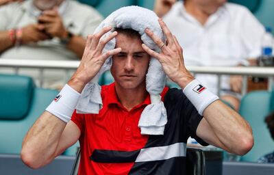 epa07477443 John Isner of the US holds ice on his head during a break against Roger Federer of Switzerland  during their Men's finals match at the Miami Open tennis tournament in Miami, Florida, USA, 31 March 2019.  EPA/RHONA WISE