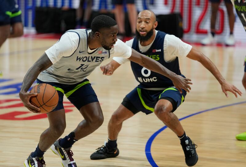 Minnesota Timberwolves Shake Milton, left, takes the ball around a teammate during a practice session in Abu Dhabi. AP
