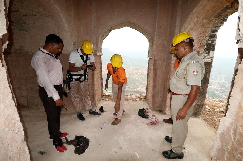 Indian disaster response officers examine the scene of a lightning strike at a watch tower in Rajasthan.