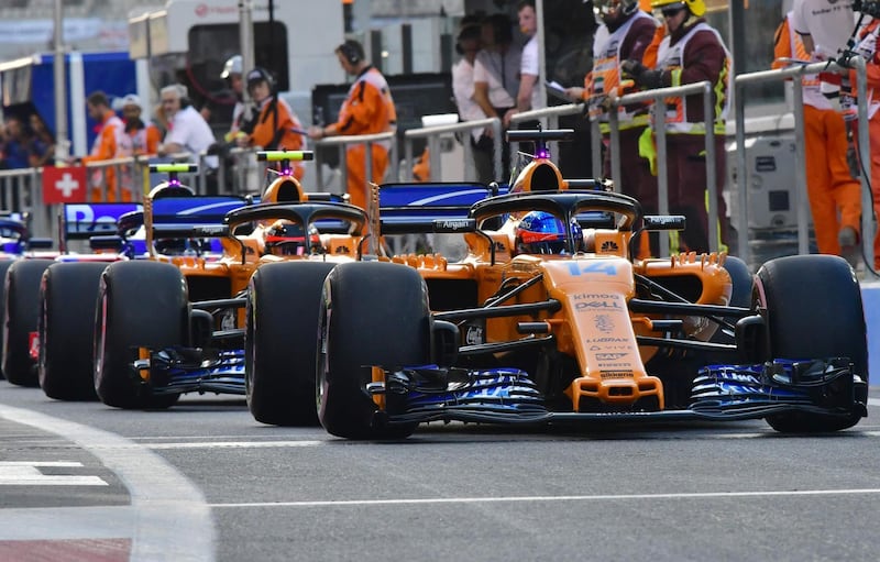 McLaren's Spanish driver Fernando Alonso, right, competes during the qualifying session. AFP