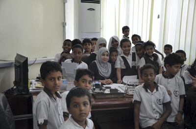 Afrah Mohammed Juma’a Khan poses with children from a local school. Courtesy Saeed Al Batati  