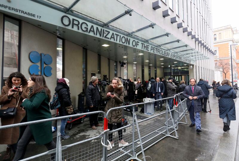 People stand outside the Opec headquarters in Vienna, Austria. The group will convene its next ministerial meeting virtually on October 4. AP Photo