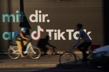 Bicyclists ride past an advertisement for social media company TikTok in Berlin, Germany. US officials are bracing for president Donald Trump rejecting the deal if it becomes obvious that it doesn’t meet criteria the president himself laid out publicly. Getty Images