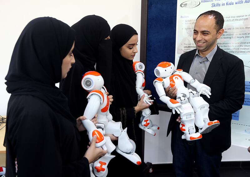 Dr Fady Al Najjar and UAEU students with the emotional robots that are being developed at Al Ain campus. Satish Kumar / The National