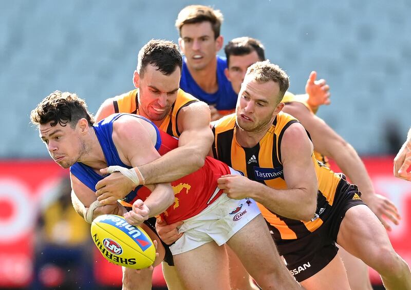 Lachine Neale of the Lions is tackled by Jonathon Ceglar and Tom Mitchell of the Hawks during the round 1 AFL match between the Hawthorn Hawks and the Brisbane Lions in Melbourne on Sunday. Getty Images