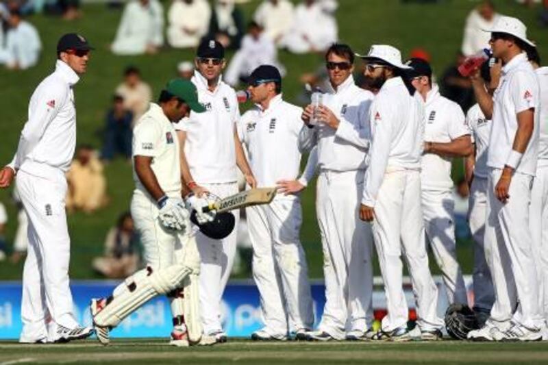 Abu Dhabi,  United Arab Emirates- January,  25, 2012: Asad Shafiq of Pakistan Walks back to the pavilion after being dismissed by England bowler Grahme Swann during the first day of the second Test match between Pakistan and England at the Sheikh Zayed Stadium in Abu Dhabi  in Abu Dhabi . (  Satish Kumar / The National ) For Sports