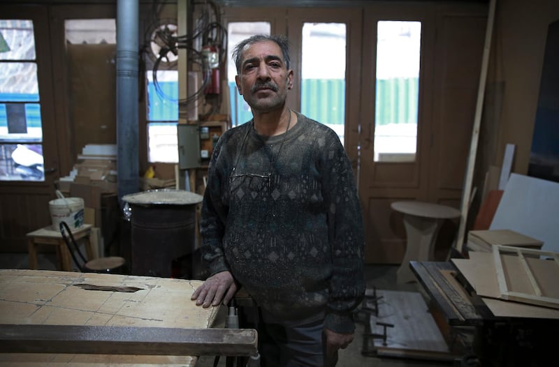 Carpenter Mohammad Reza Tajik is interviewed by The Associated Press about Iran's 1979 Islamic Revolution at his workshop, in northern Tehran, Iran. AP
