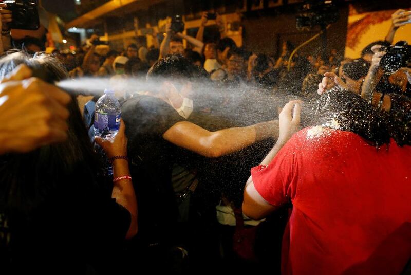 Police use pepper spray on protesters in Hong Kong on November 6, 2016, a day before China’s parliament was expected to announce its interpretation of the territory’s Basic Law to resolve a controversy over the swearing in of two legislators. Tyrone Siu / Reuters