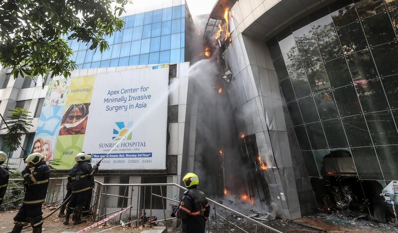 Firefighters battle a fire at a Covid-19 hospital inside a mall in Mumbai. EPA