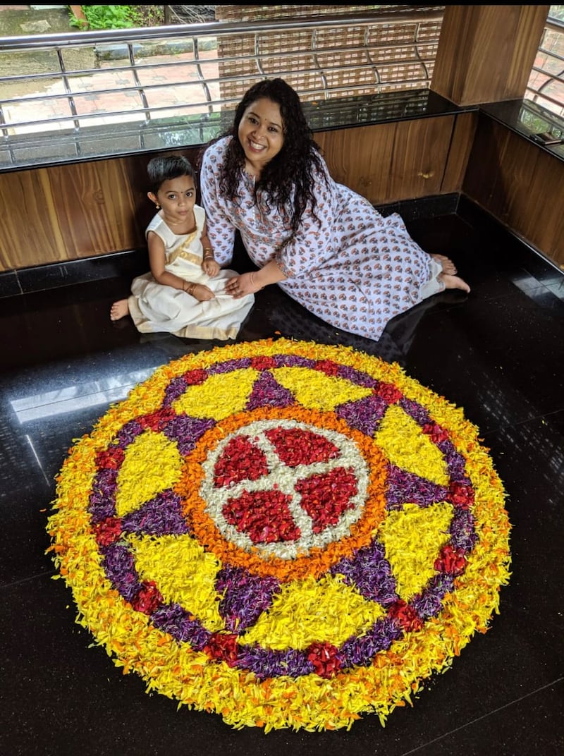 Aarti Jhurani, right, and her niece with their pookkalam. Aarti Jhurani / The National
