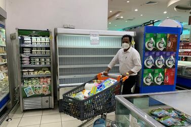 A man walks in front of shelves empty of French products at a Supermarket in Kaifan, Kuwait. French goods have already been pulled from supermarket shelves in some Gulf states. Reuters