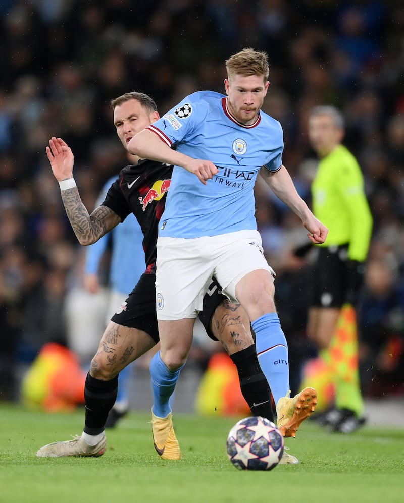 Kevin De Bruyne is challenged by David Raum. Getty