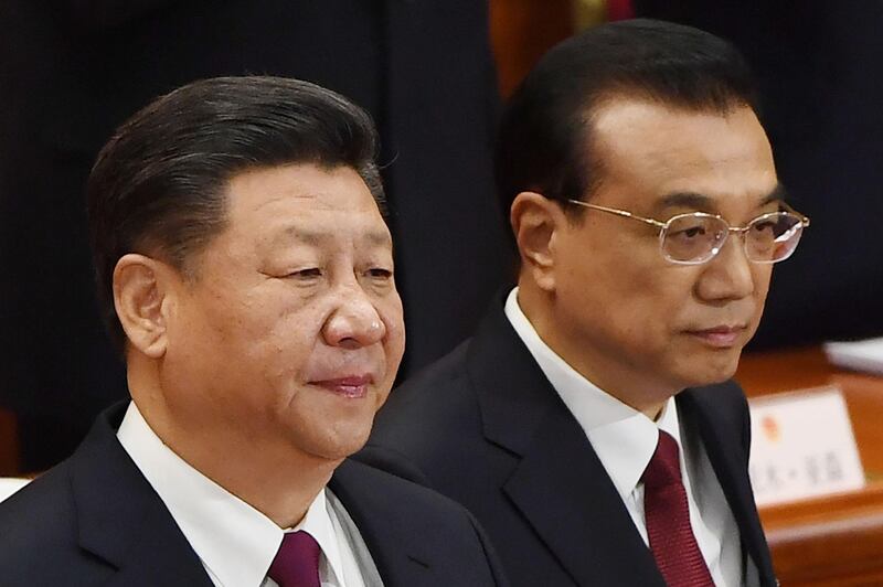 Chinese President Xi Jinping (L) and Premier Li Keqiang arrive for the opening session of the National People's Congress, China's legislature, in Beijing's Great Hall of the People on March 5, 2018.
Thousands of Chinese legislators erupted into enthusiastic applause over plans to give President Xi Jinping a lifetime mandate to mould the Asian giant into a global superpower. / AFP PHOTO / GREG BAKER