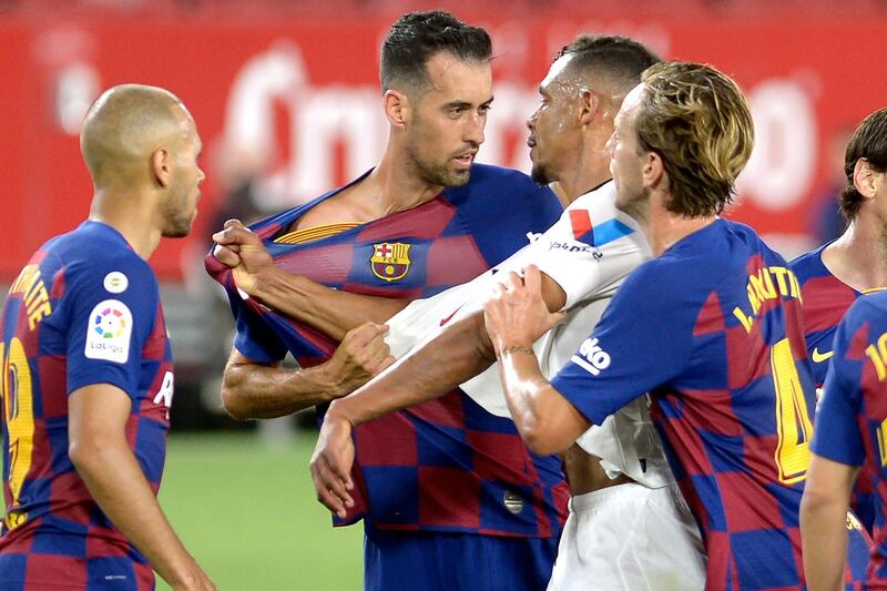 Barcelona's Spanish midfielder Sergio Busquets argues with Sevilla's Brazilian midfielder Fernando. AFP