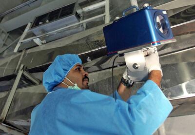 An IAEA inspector sets up surveillance equipment at the Uranium Conversion Facility of Iran just outside the city of Isfahan in 2005. AP