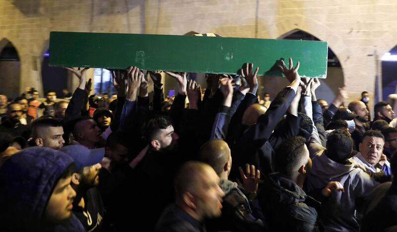 Palestinians carry the coffin of Iyad Hallak, a disabled Palestinian man who was shot dead by Israeli police after they mistakenly thought he was armed with a pistol, during his funeral in Jerusalem late on May 31, 2020.  / AFP / AHMAD GHARABLI
