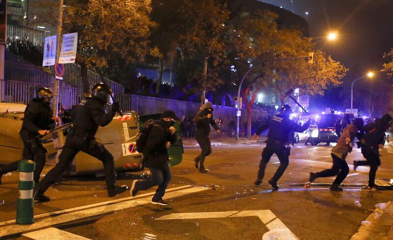 Protesters and Catalan regional police clash in the surroundings of Camp Nou stadium. EPA