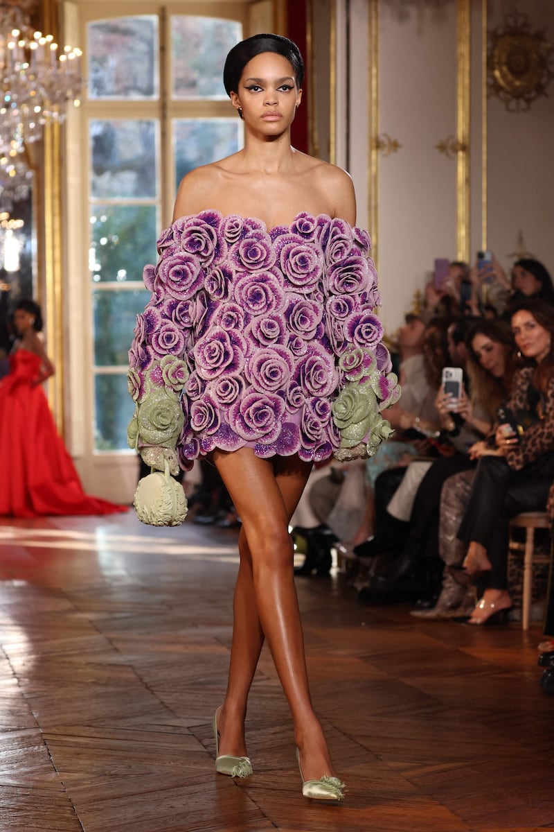 A strapless swing dress made from lilac flowers. AFP