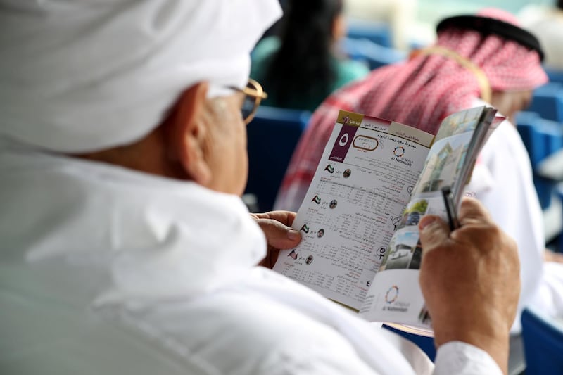 Dubai, United Arab Emirates - March 17, 2019: People study the form and mark their race cards at the Dubai World Cup. Saturday the 30th of March 2019 at Meydan Racecourse, Dubai. Chris Whiteoak / The National