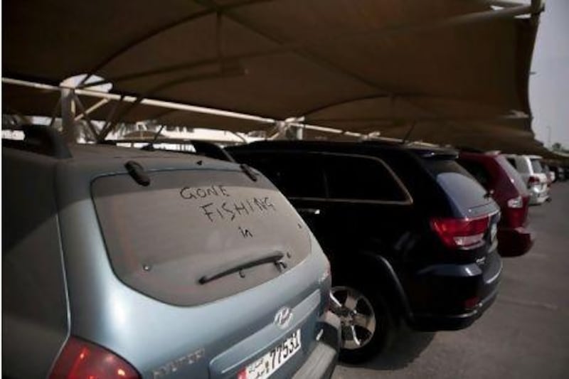 Several cars sit covered in dust, seemingly abandoned at the Abu Dhabi Airport short-term parking lot as seen on Wednesday afternoon, August 1, 2012.  Silvia Razgova / The National