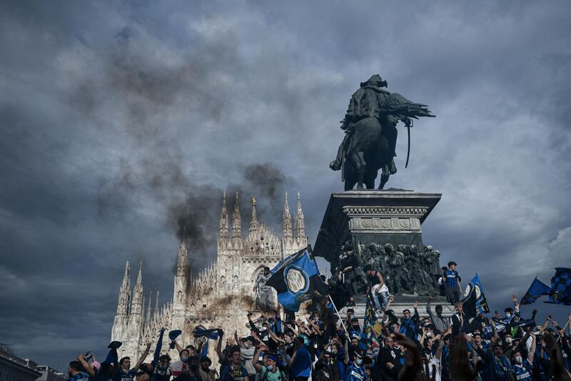 FC Internazionale supporters celebrate at Piazza Duomo in Milan, after their team won the Italian Serie A Championship title for the first time since 2010. AFP