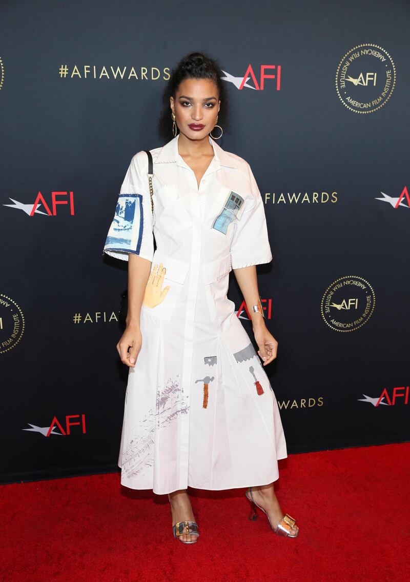 Actor Indya Moore ('Pose') dazzles in a Lorod Resort 2019 shirt dress, paired with metallic sandals and a Louis Vuitton handbag. REUTERS