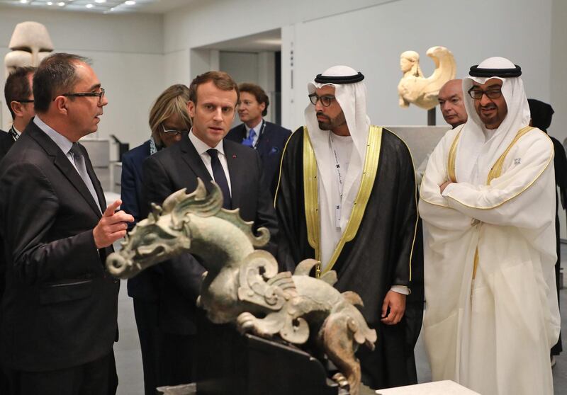 President-Director of the Louvre Museum, Jean-Luc Martinez (L) speaks to French President Emmanuel Macron (2L), Chairman of Abu Dhabi's Tourism and Culture Authority, Mohamad Khalifa al-Mubarak, Deputy Director of the Louvre Abu Dhabi (2R) and Abu Dhabi Crown Prince Mohammed bin Zayed Al-Nahyan as they visit the Louvre Abu Dhabi Museum on November 8, 2017 during its inauguration on Saadiyat island in the Emirati capital.  / AFP PHOTO / ludovic MARIN